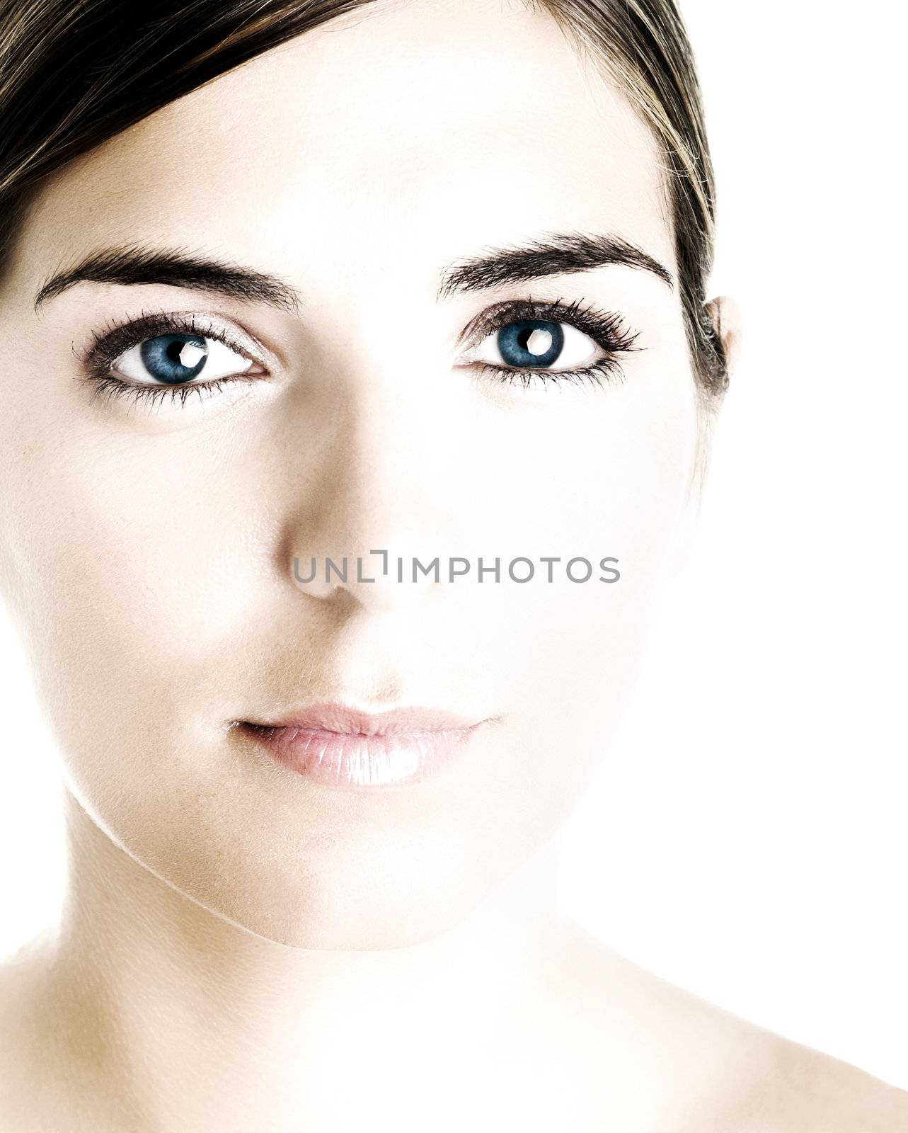 Face of a young beautiful woman with a great blue eyes. (little bit overexposed)