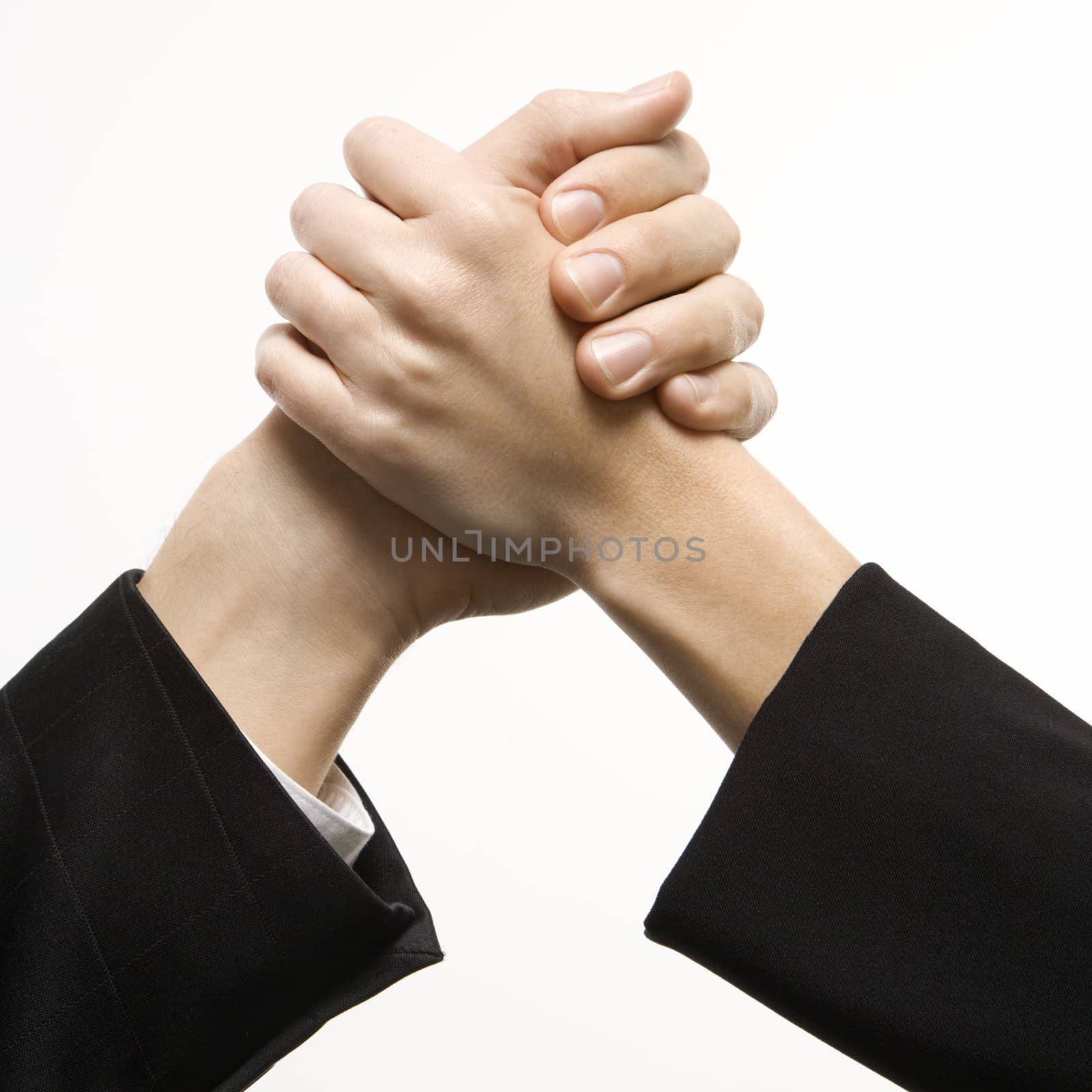 Close-up of hands of Caucasian man and woman arm wrestling.