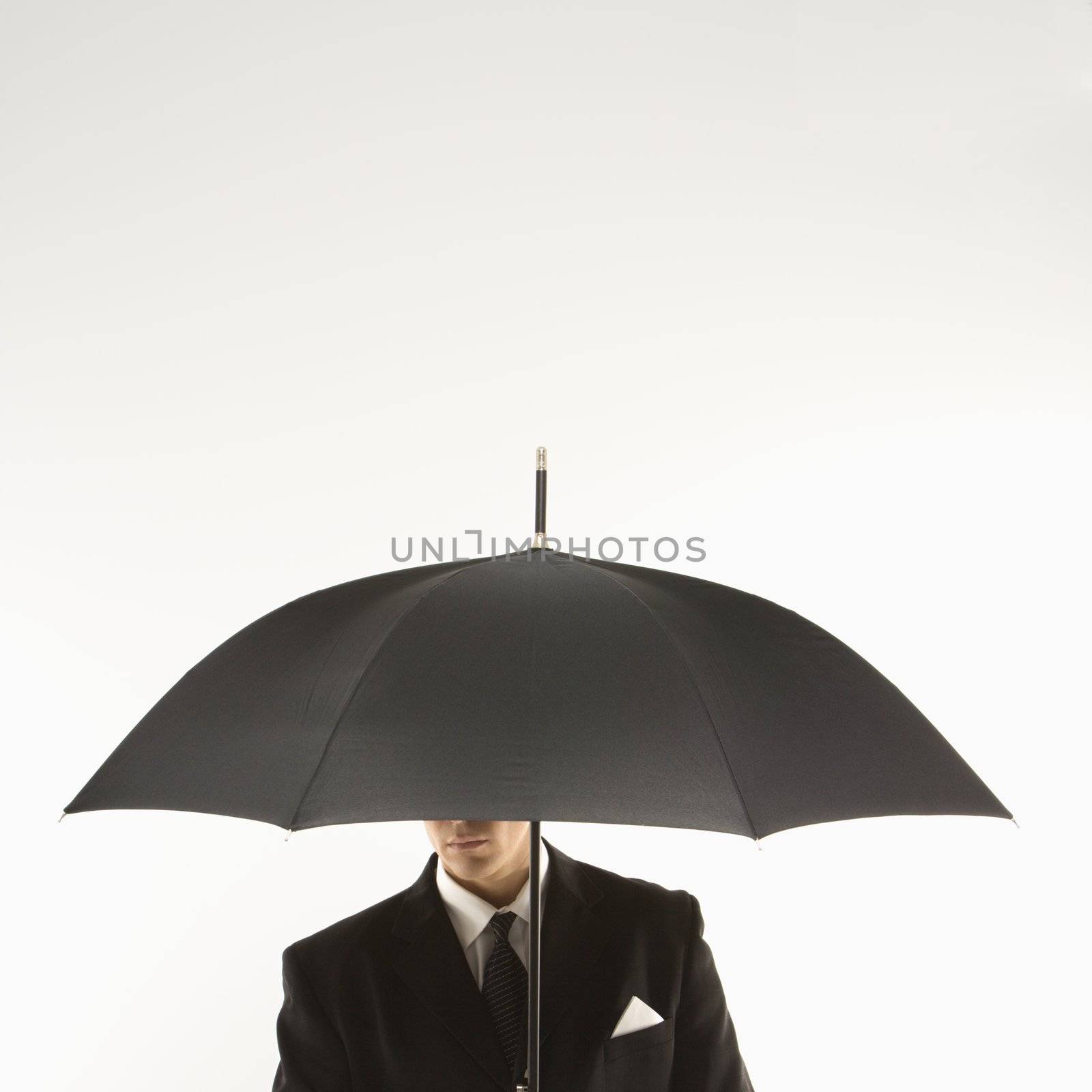 Businessman with umbrella. by iofoto