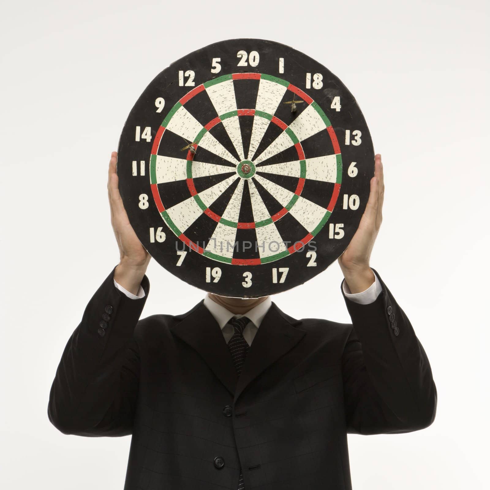 Dartboard in front of face. by iofoto