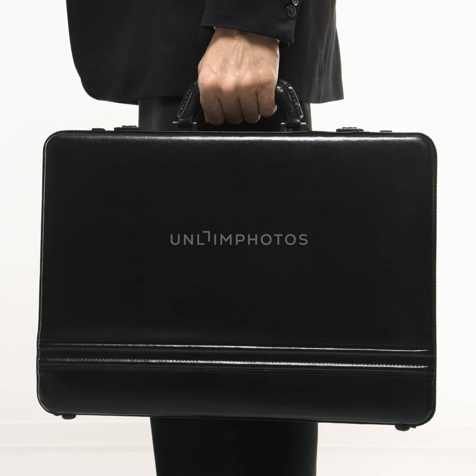 Caucasian mid-adult man's hand holding briefcase.