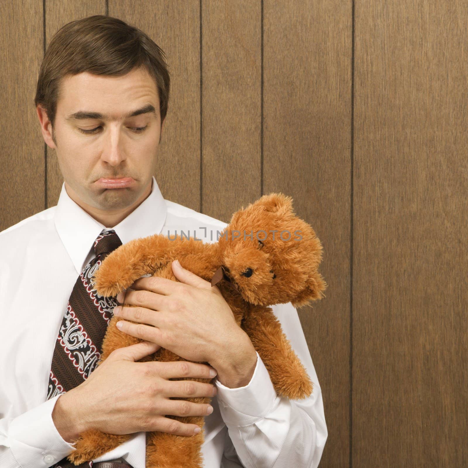 Man with teddy bear. by iofoto