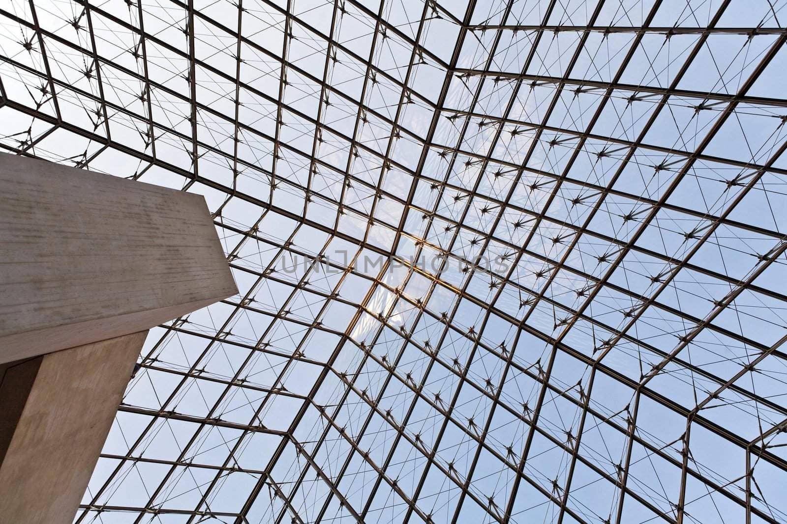 The photo is made under a glass dome of a pyramid in the Louvre