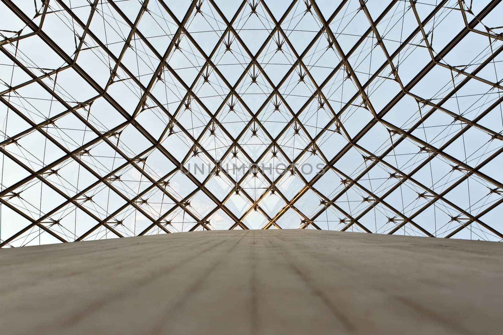 The photo is made under a glass dome of a pyramid in the Louvre