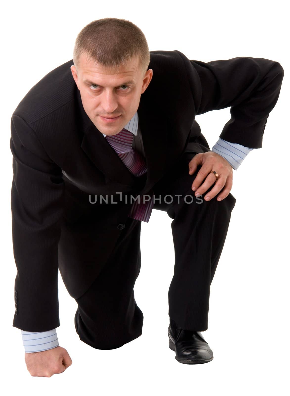 serious businessman sitting against isolated white background