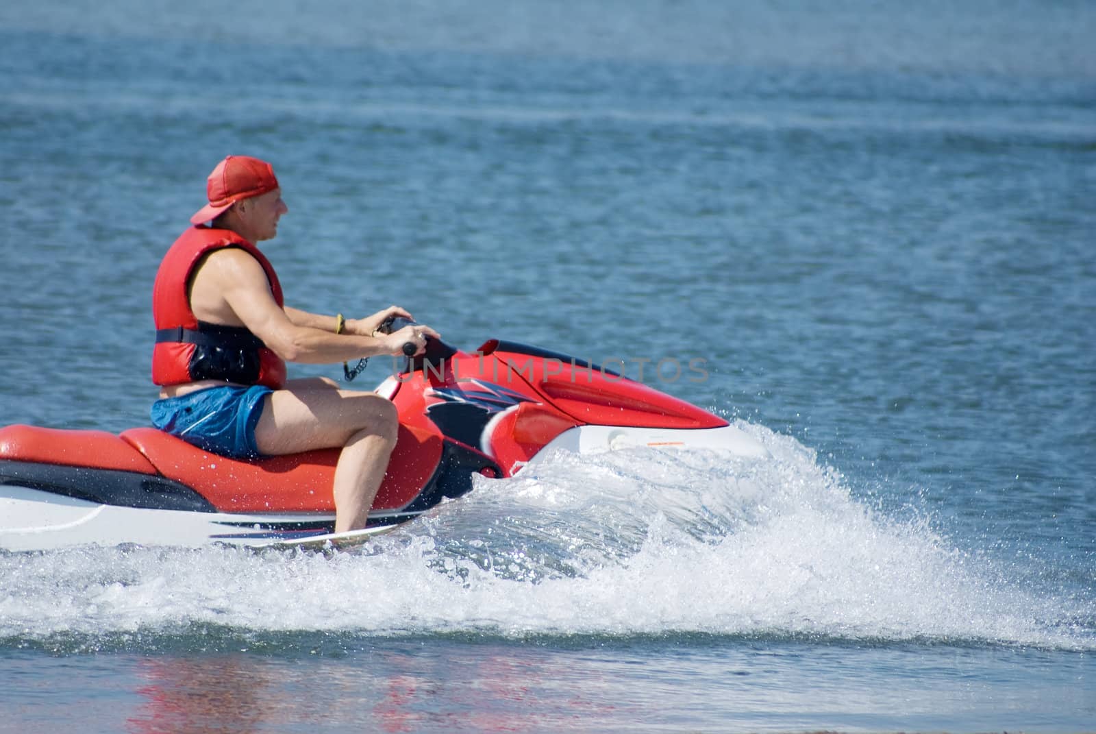 The man goes for a drive on a water motorcycle