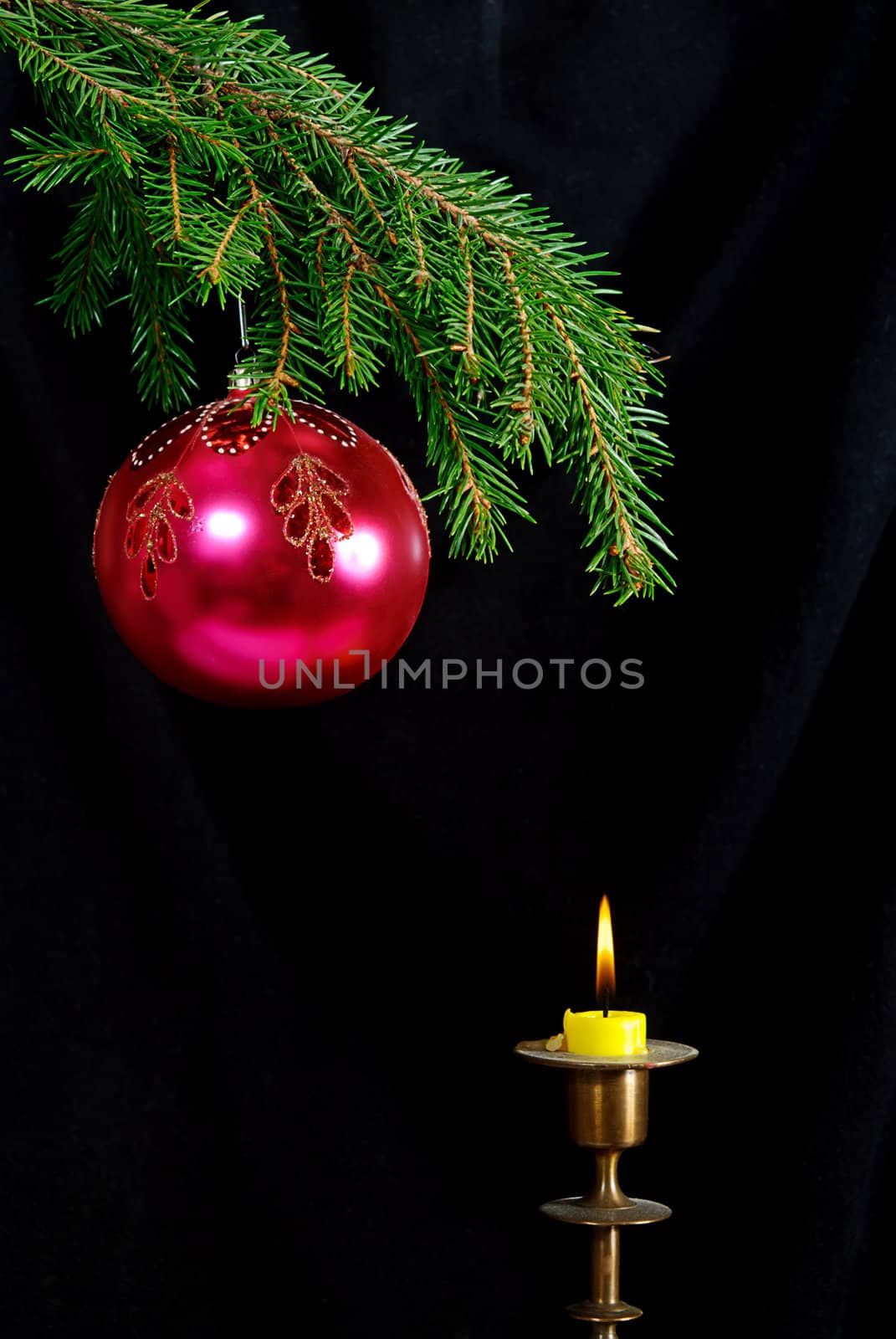 green  fir tree  twig and red ball and candle