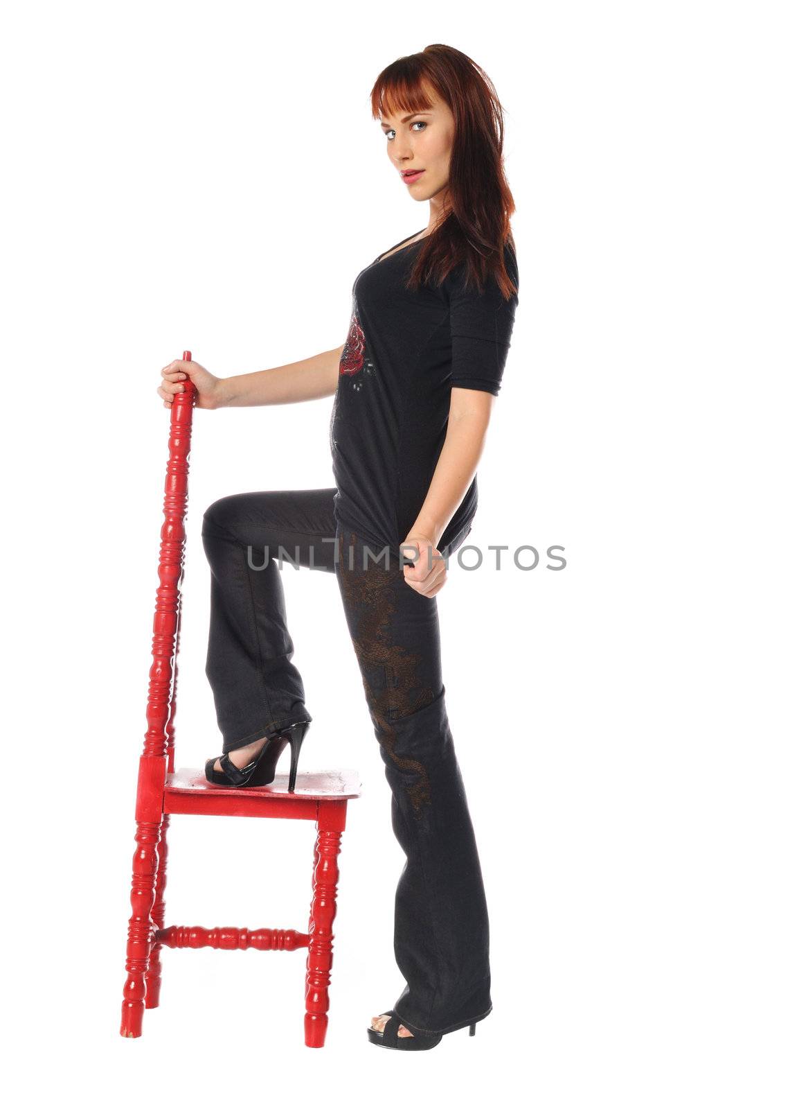 Attractive young woman in a tall back chair on a white background