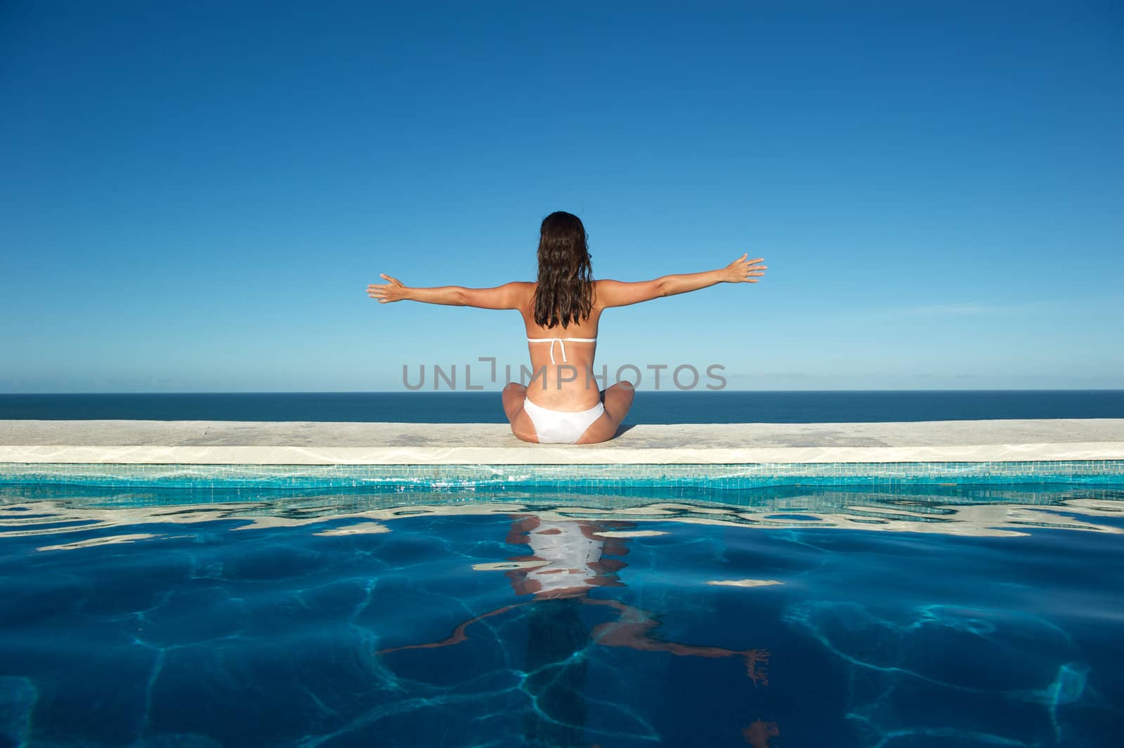 Woman relaxing in the spa swimming pool  by swimnews