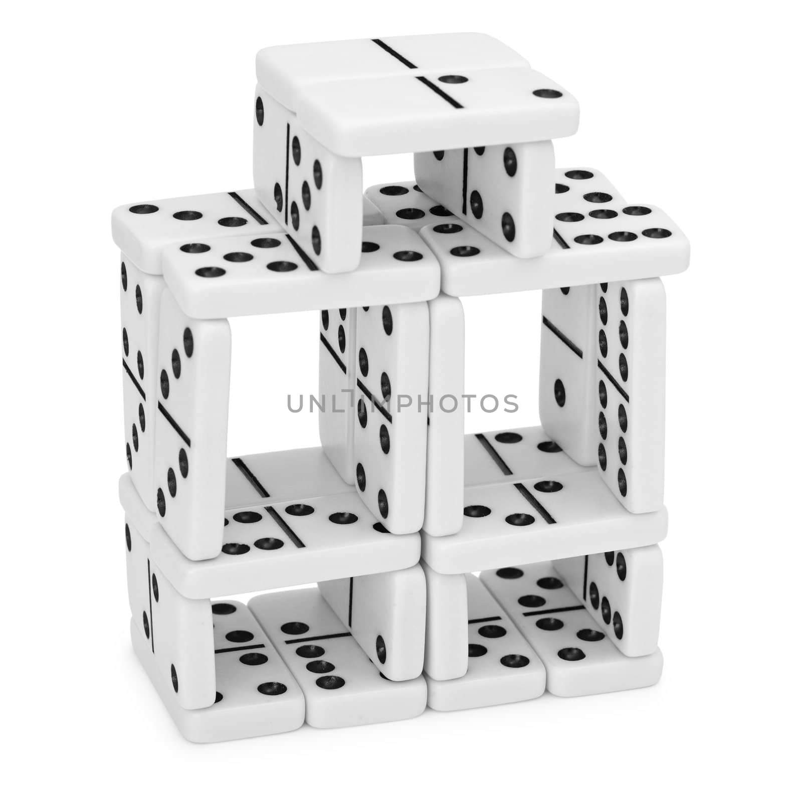 Intricate construction of dominoes on a white background