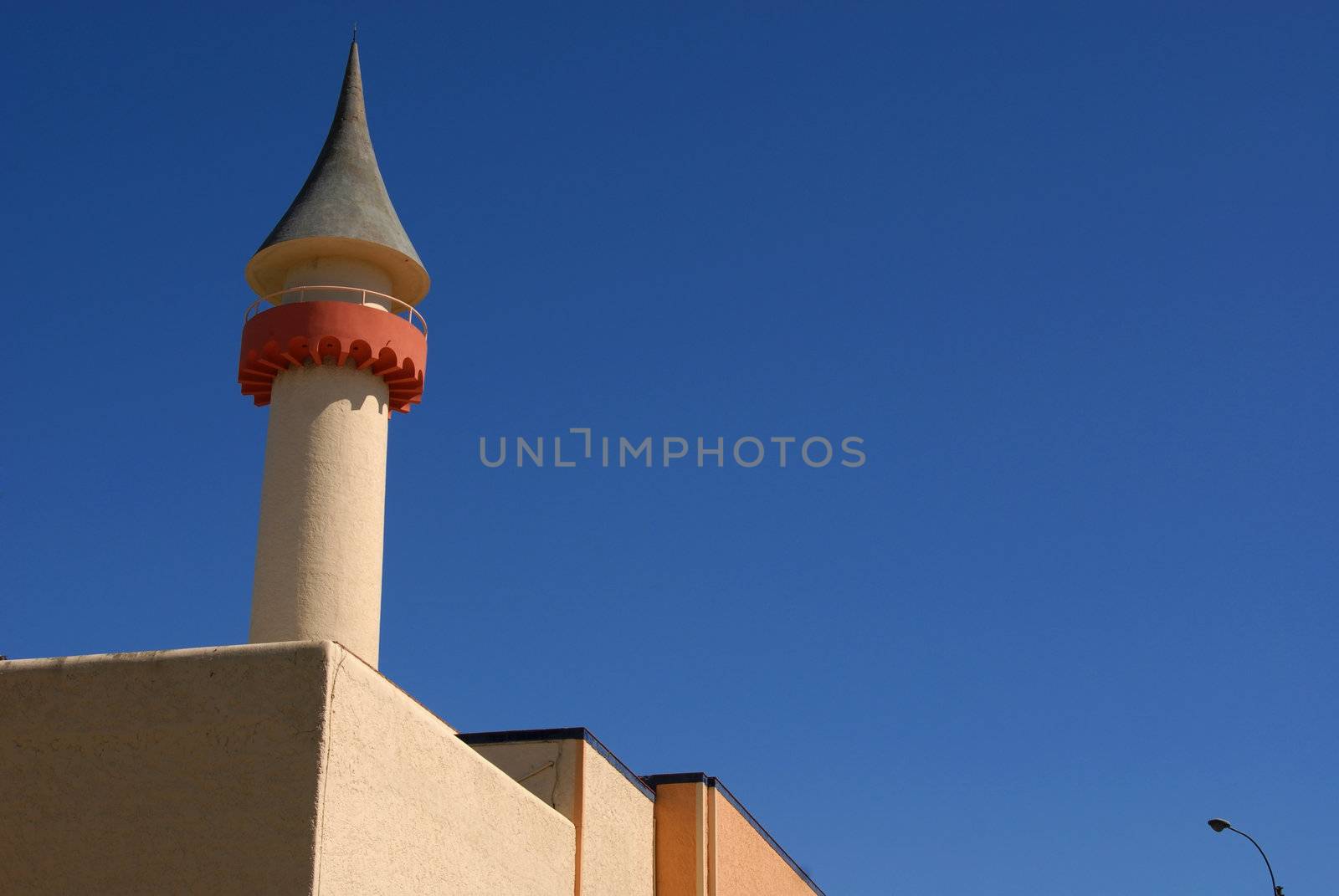 Tower. Upper part of a building on a blue sky background