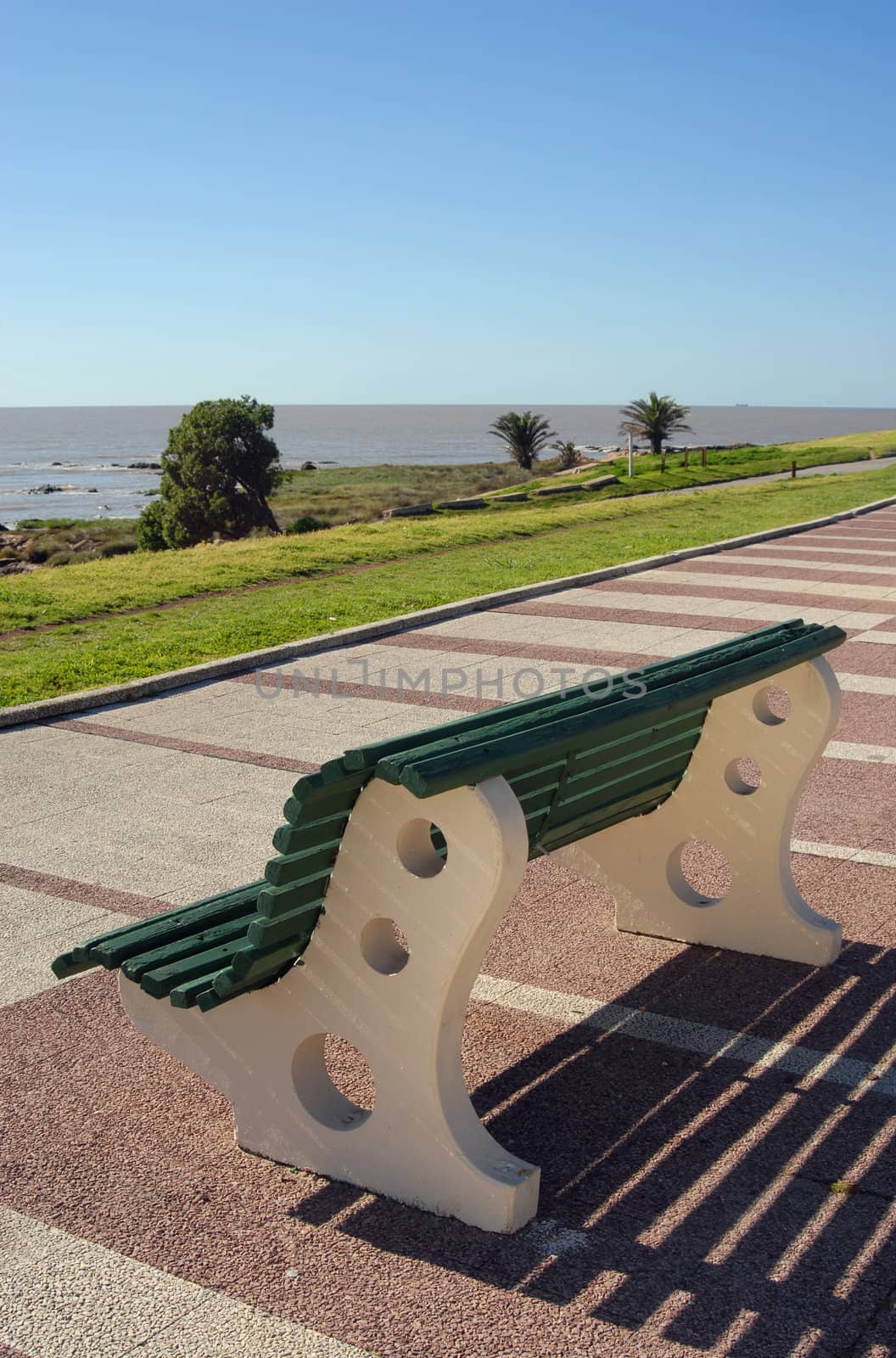 Wooden bench facing the beach.
