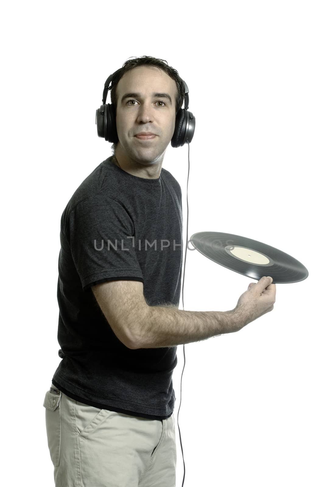 A young man wearing a set of headphones about to throw away an old LP record, isolated against a white background