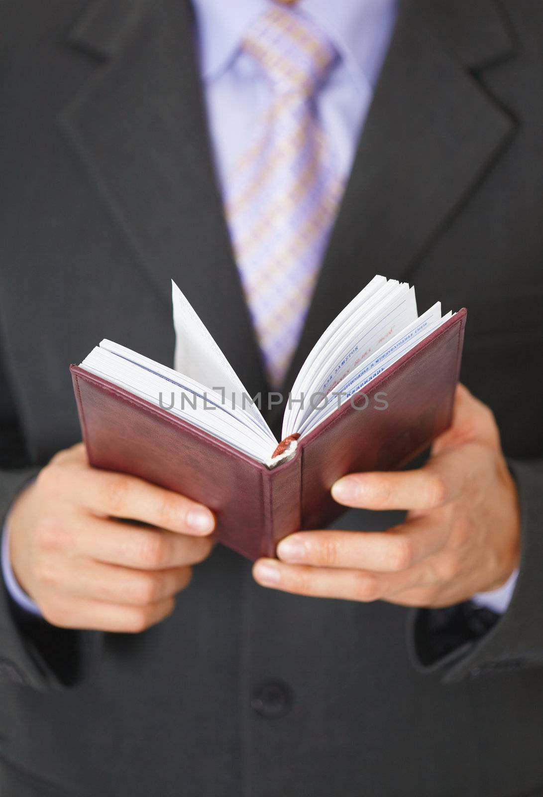 A businessman checks the schedule of the day in the organizer