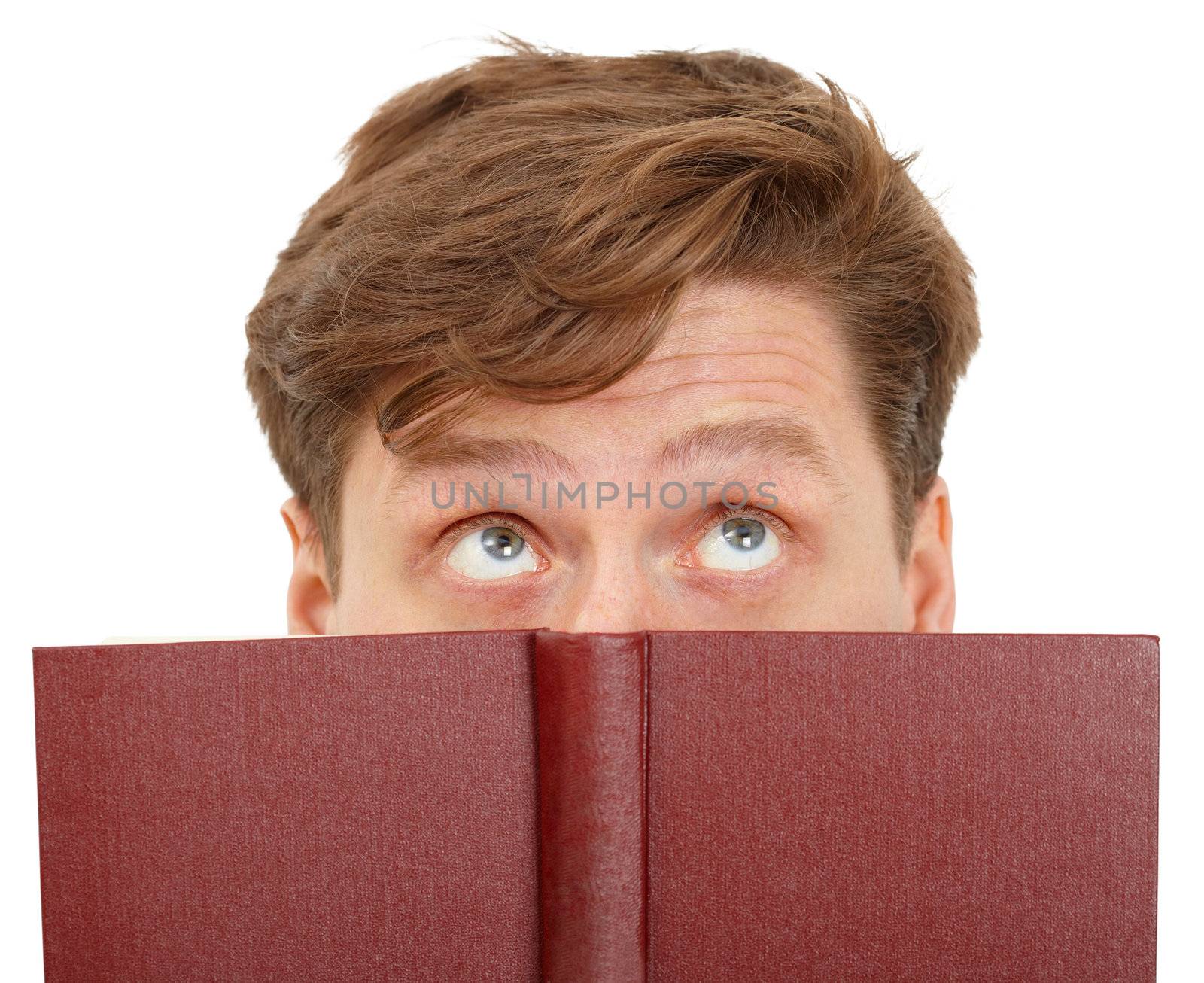 Man dreamily reading a book - close-up of the eyes