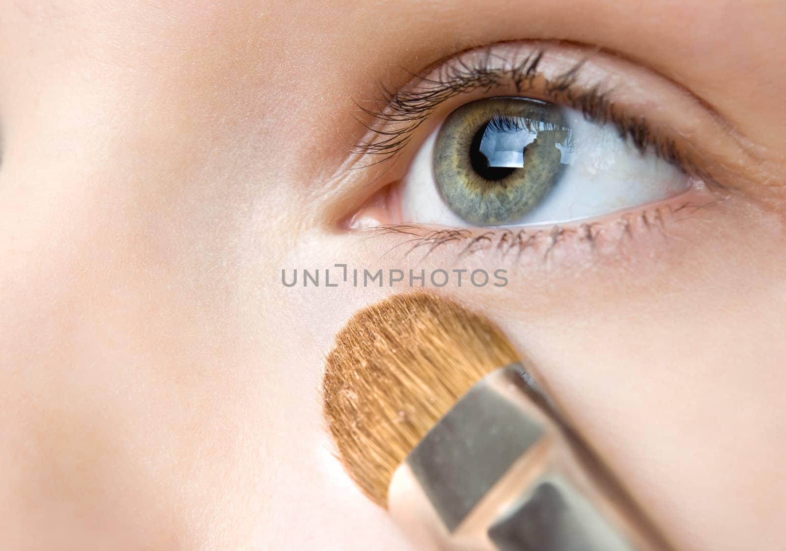 applying powder with special brush, selective focus, blue version