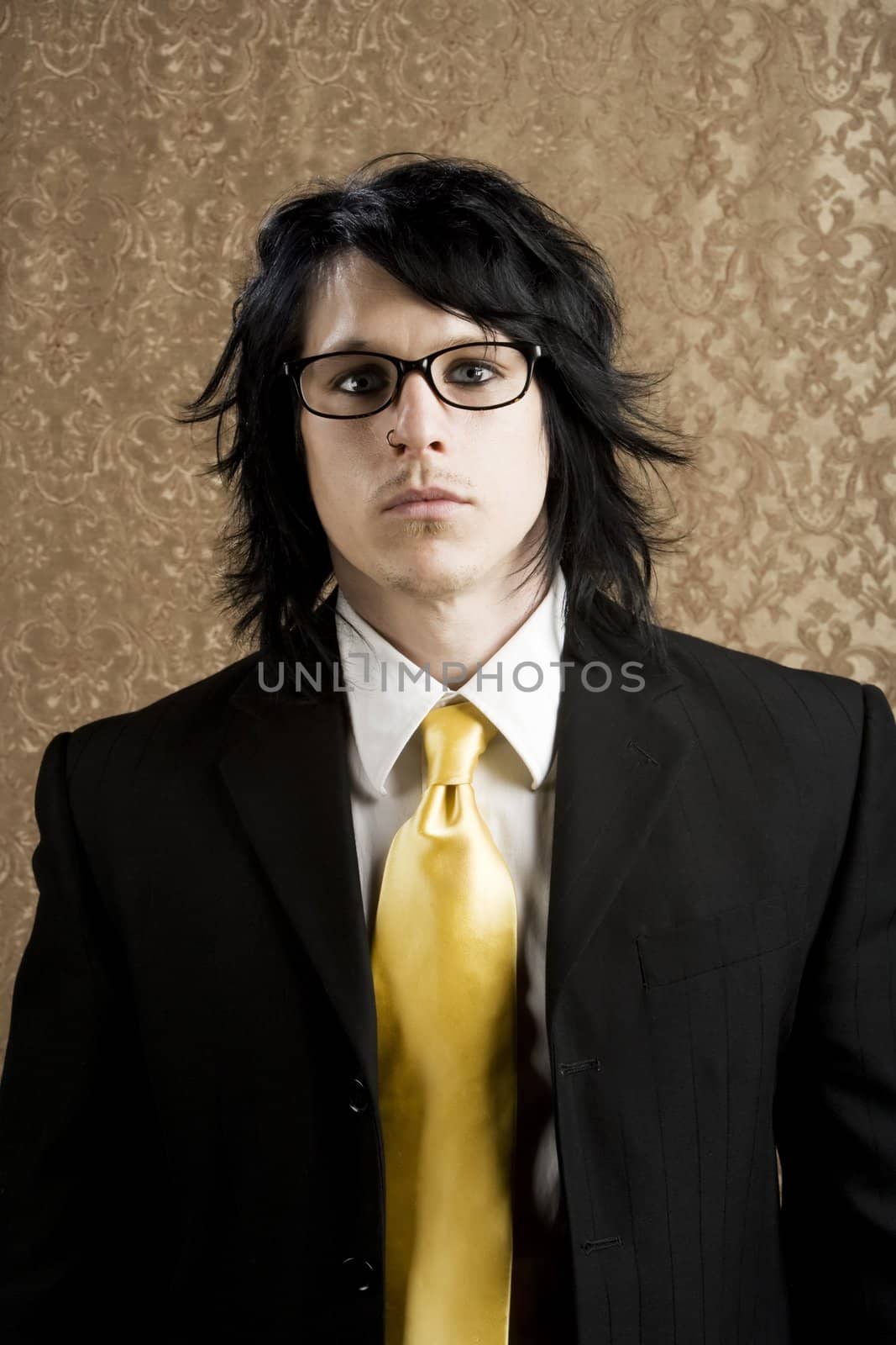 Well-dressed businessman with a yellow tie and thick glasses