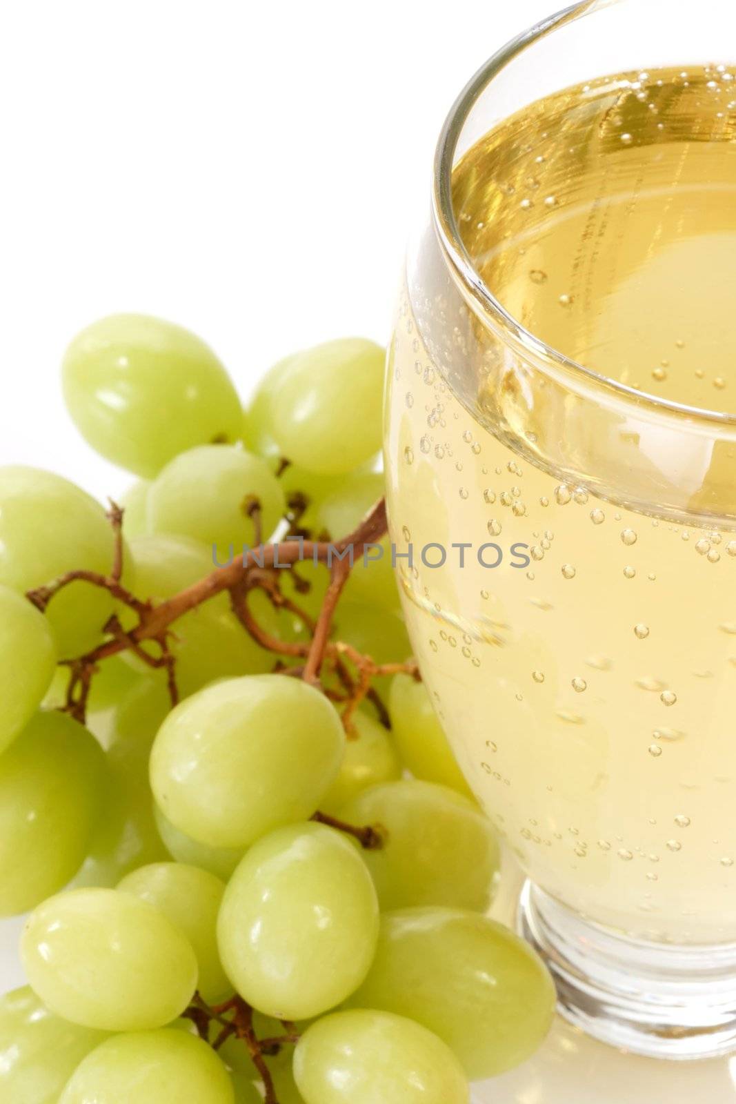 Spritzer in a glass with grapes on white background