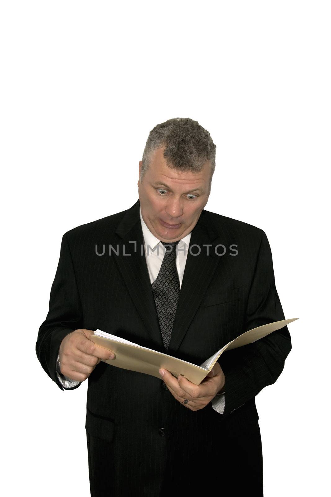 A middle-aged businessman looking shocked while reading from a folder.