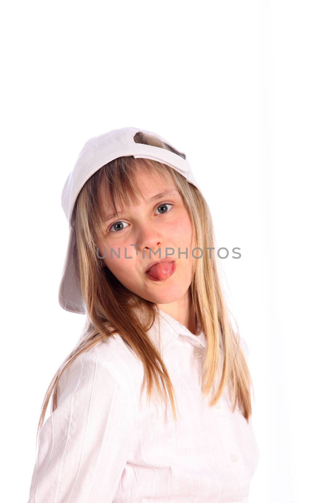 young, blond girl with white cap stretches out her tongue