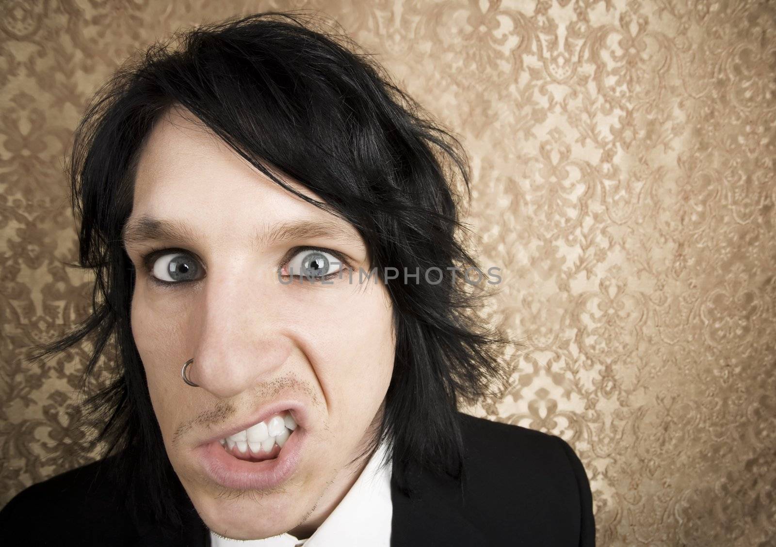 Wide angle closeup of a handsome angry man 