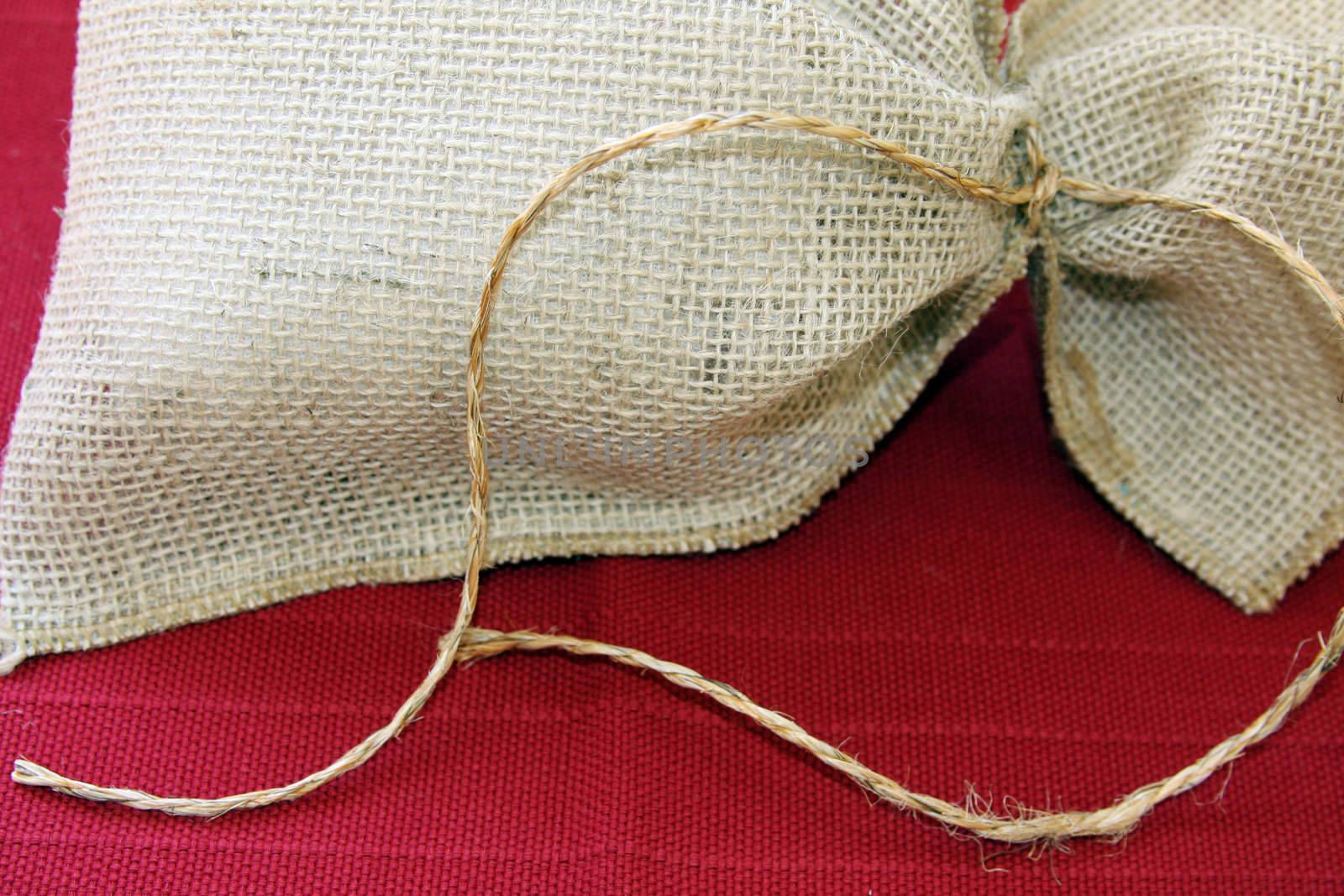 Burlap bag on red texture
