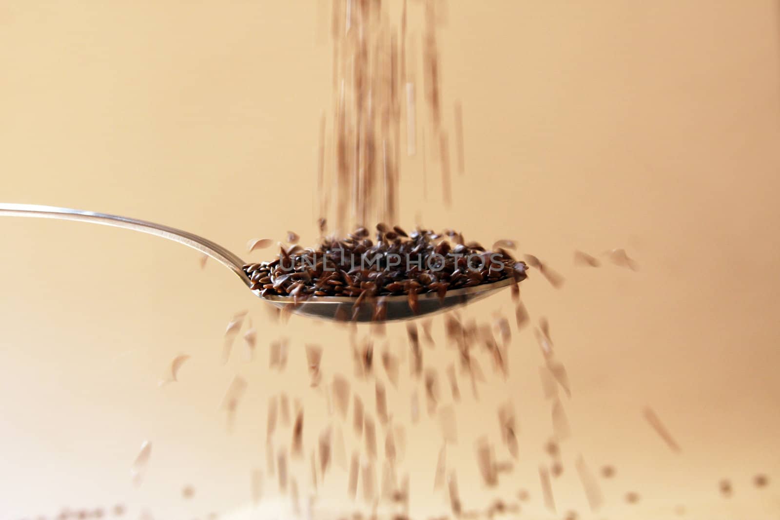 Flax seed falling in spoon by LuBueno