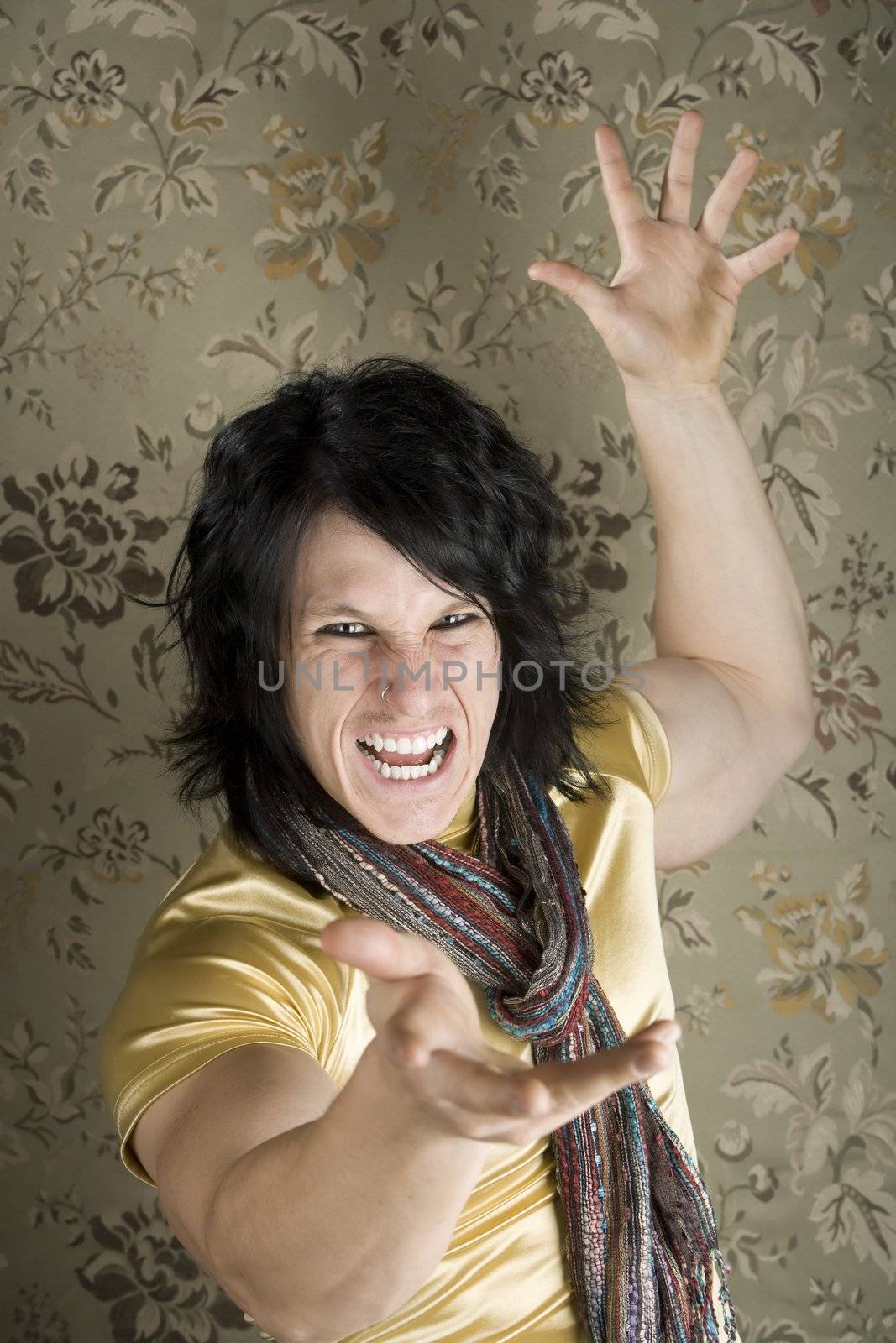 Rock and Roll Hipster in a tight yellow shirt gesturing with his hands