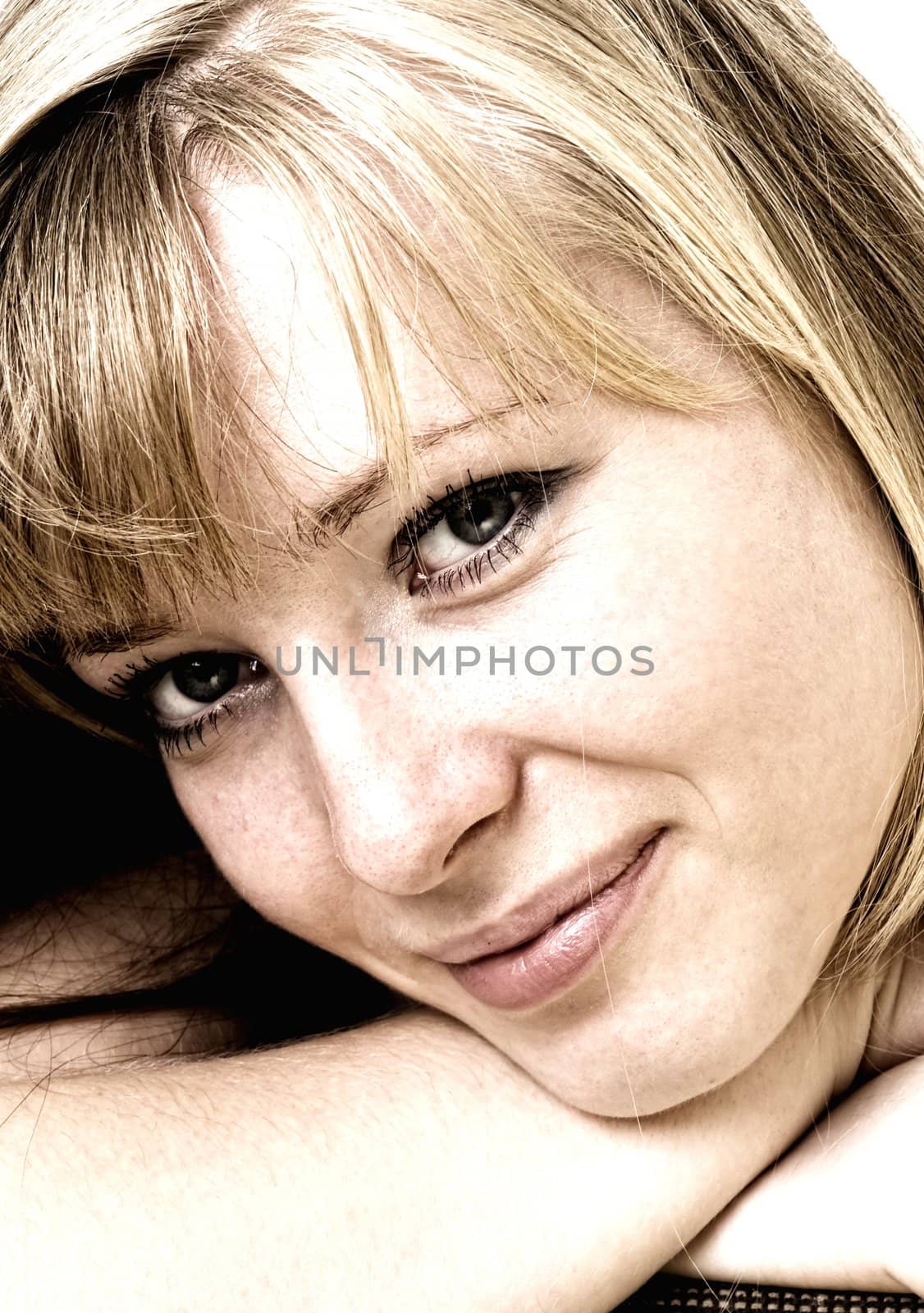 Portrait of the smiling young woman. The beautiful face close up.