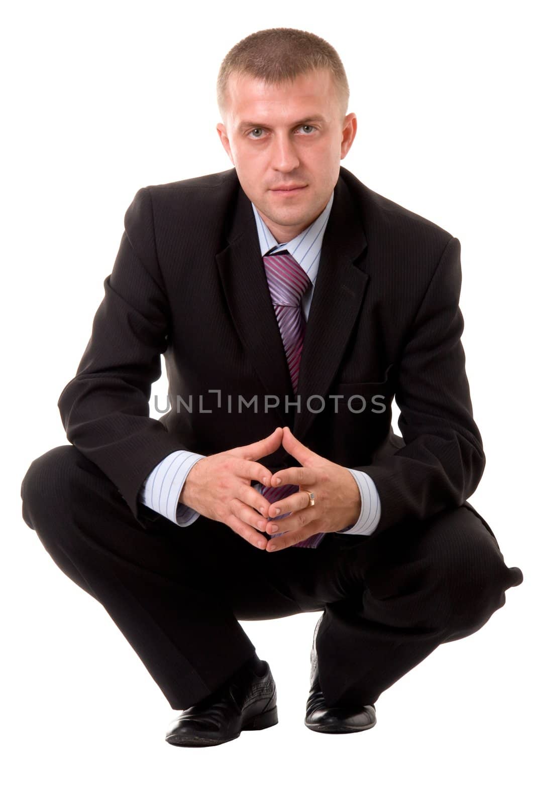 serious businessman sitting against isolated white background