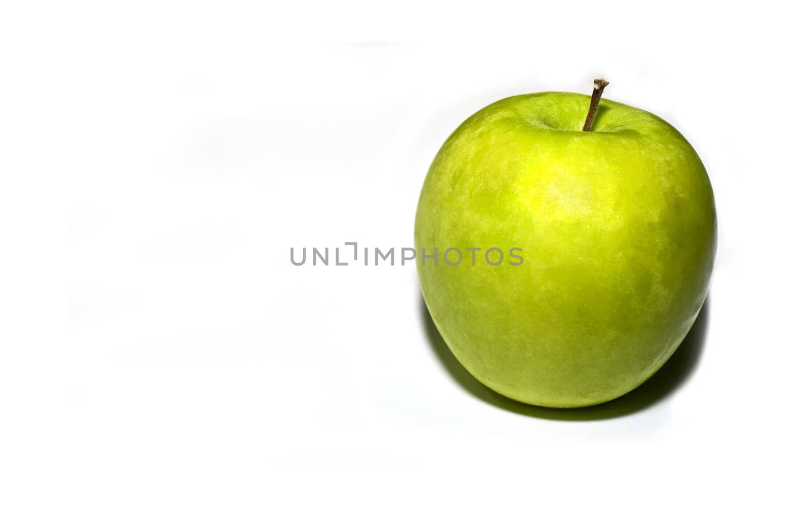 A ripe granny SMith apple over a plain white background  