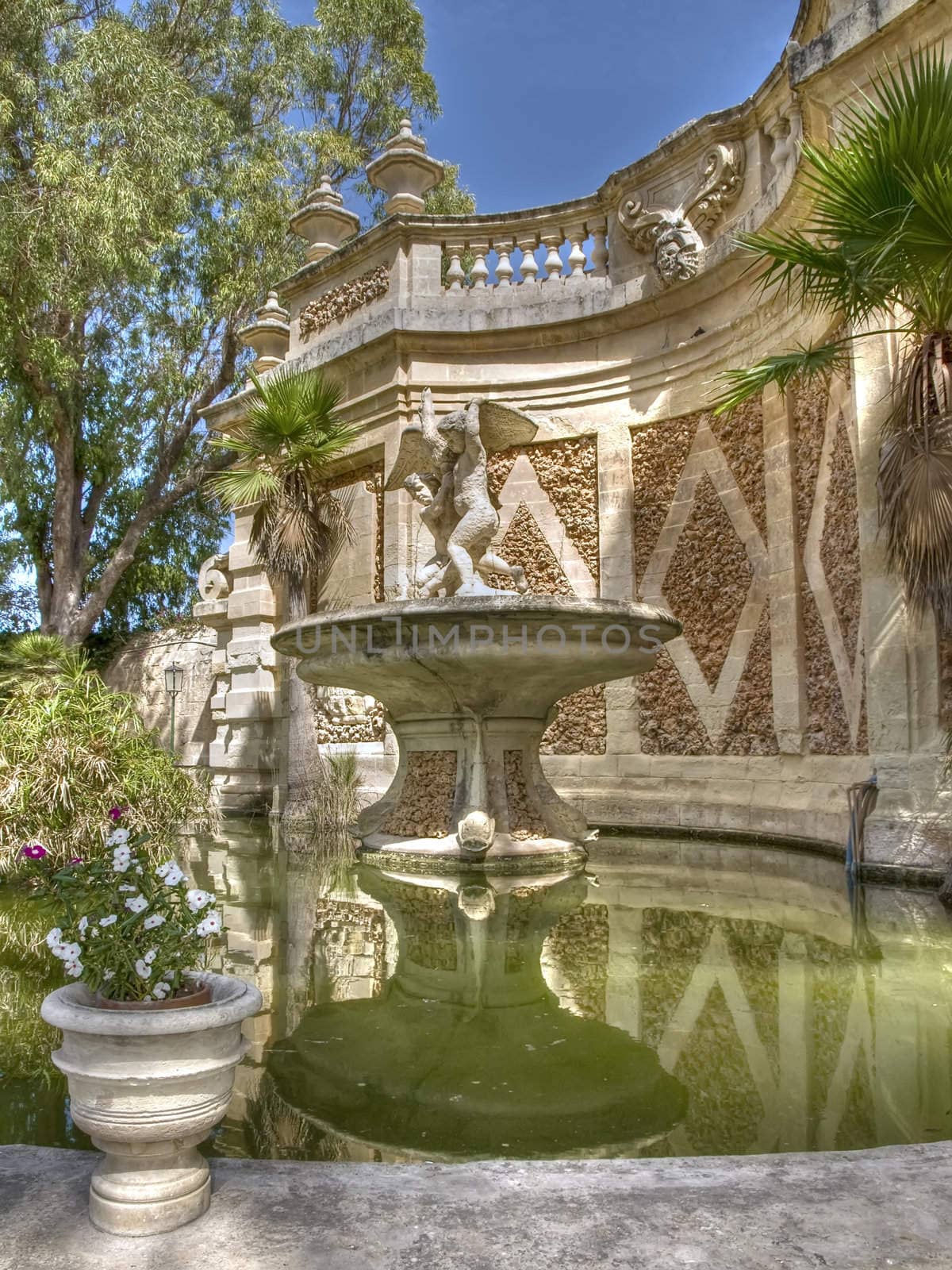 A medieval fountain in a public garden in Malta