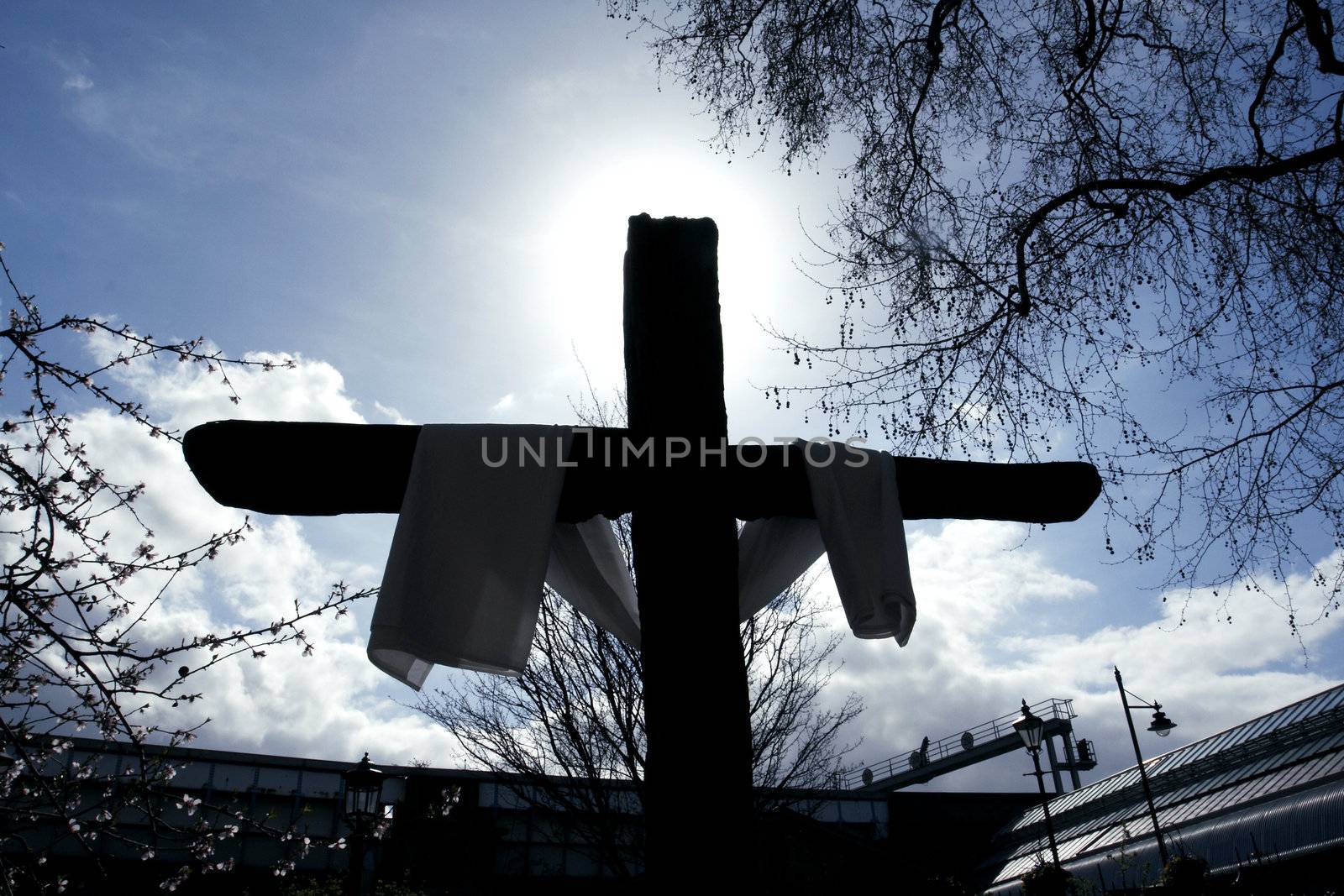 cross draped in backlight