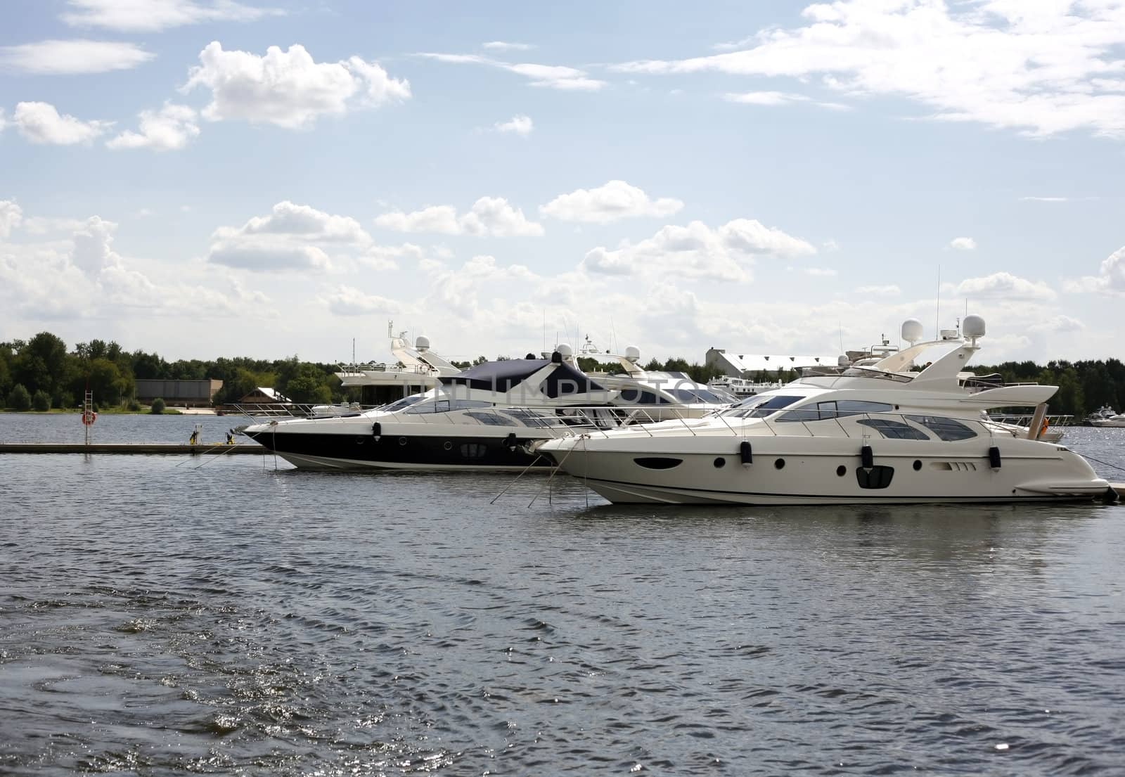 Two boats in river on a background of city
