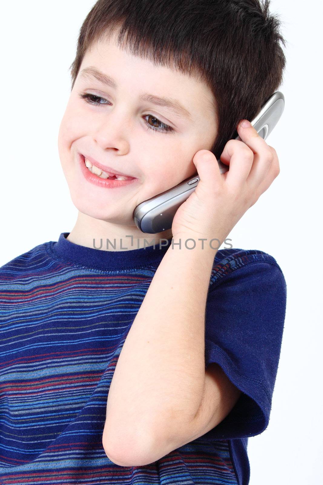 Small boy calling from mobile phone to friend on white background