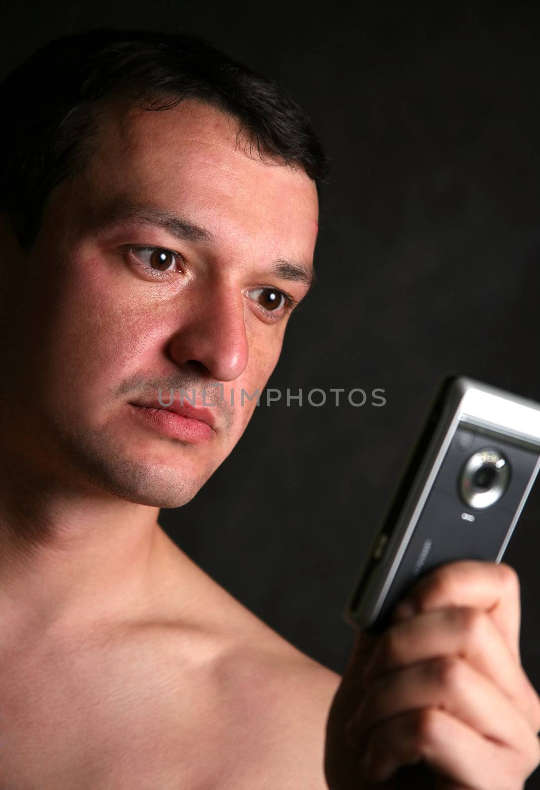 Portrait of the man with the phone in studio