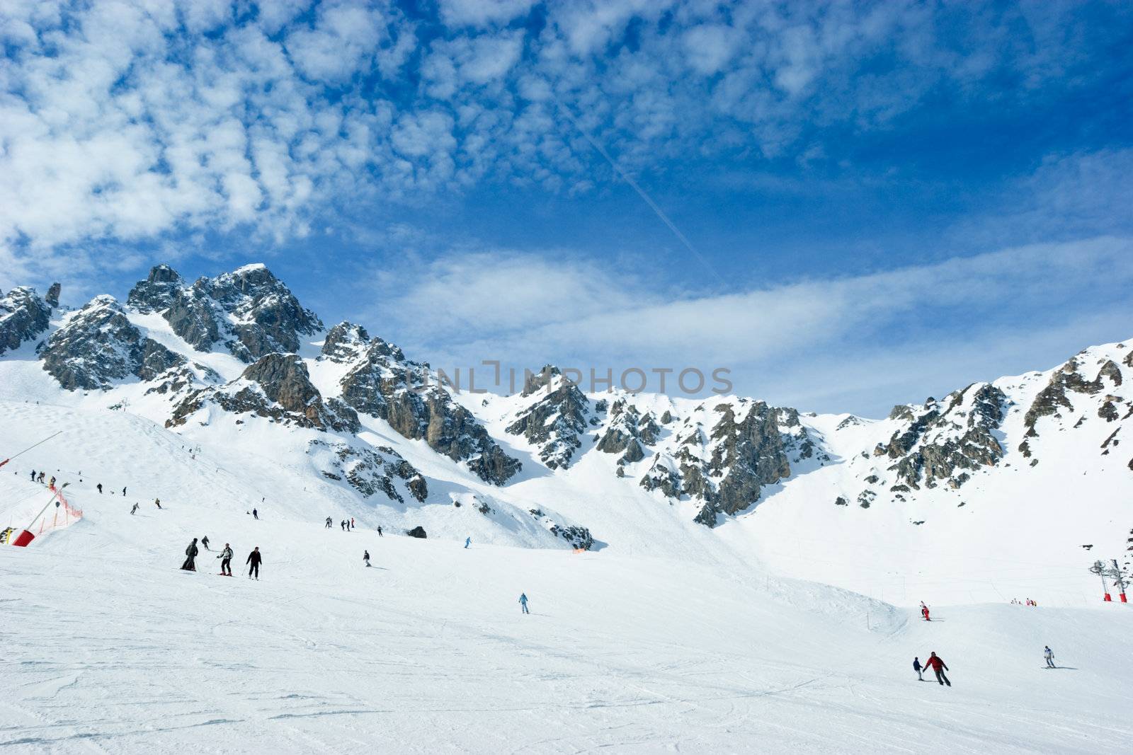 Skiers on a piste at Courchevel ski resort, French Alps