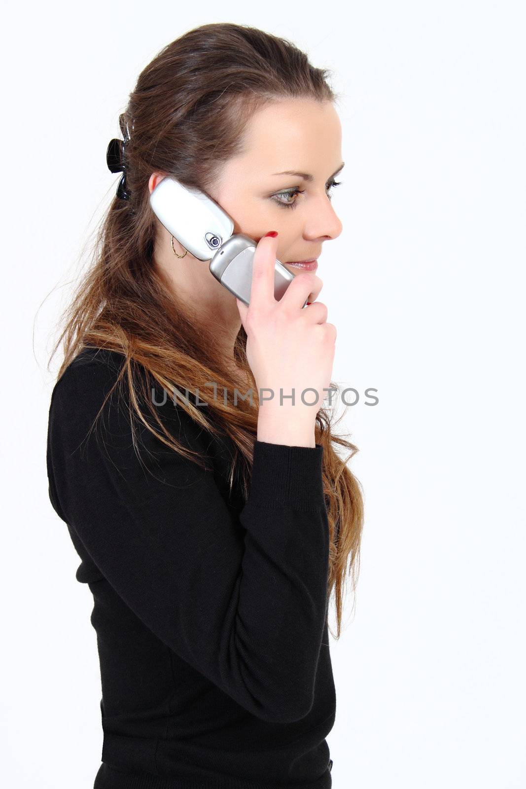 The attractive woman talks by a mobile phone on a white background 