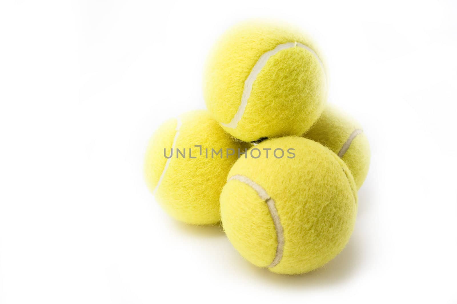 Four tennis balls isolated on white background