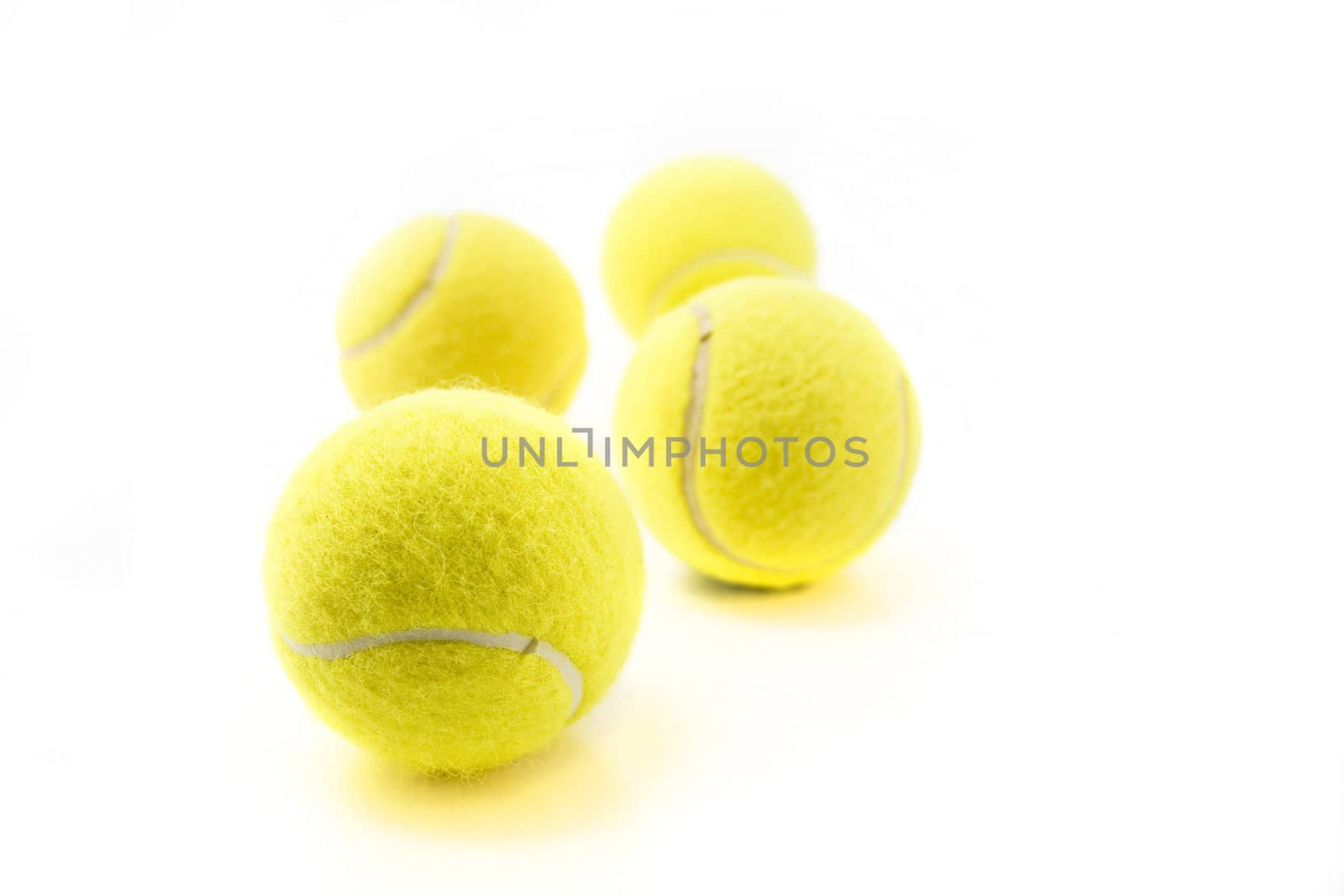 Four tennis balls isolated on white background