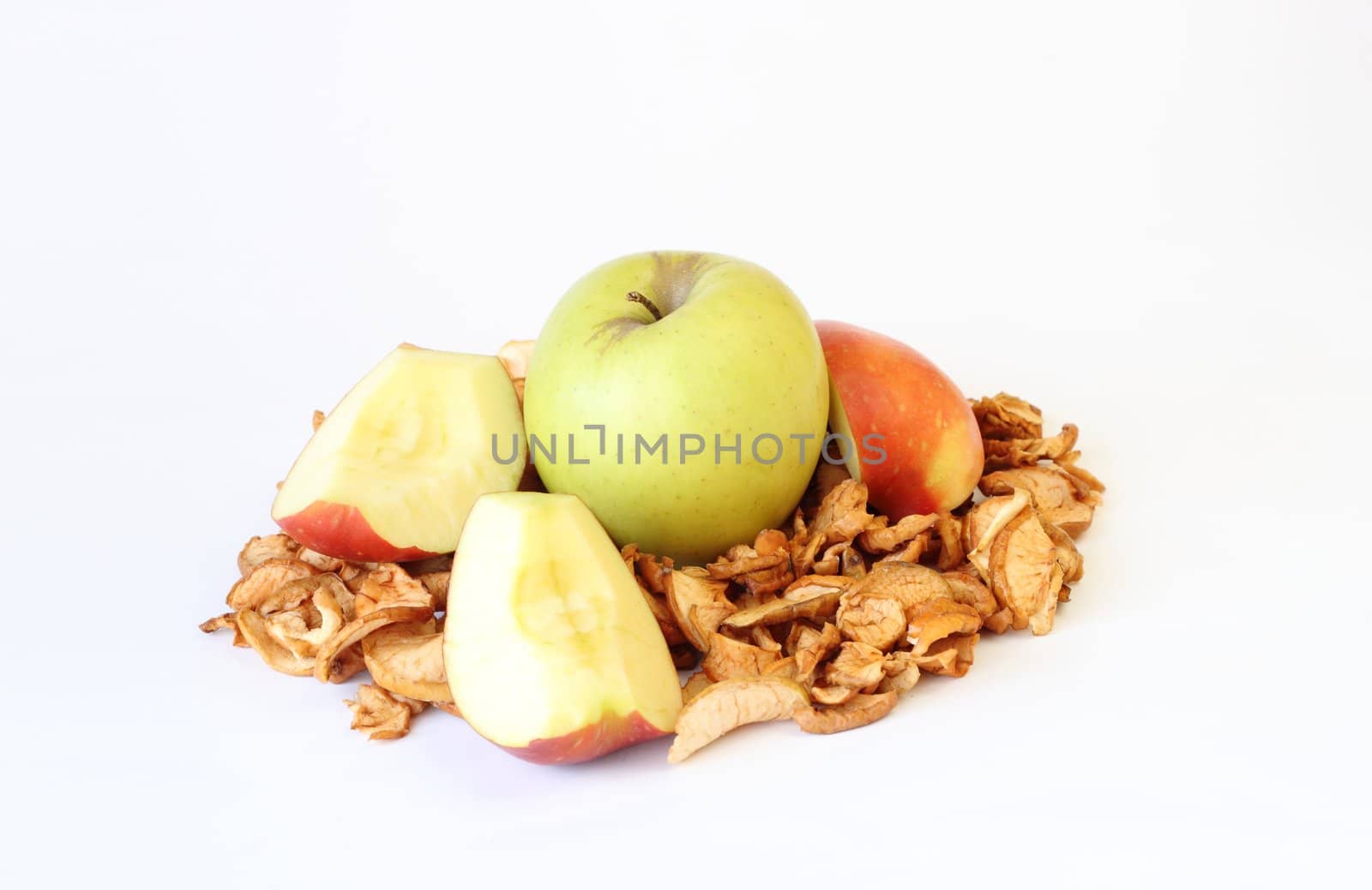 green sliced and dried apples on white background