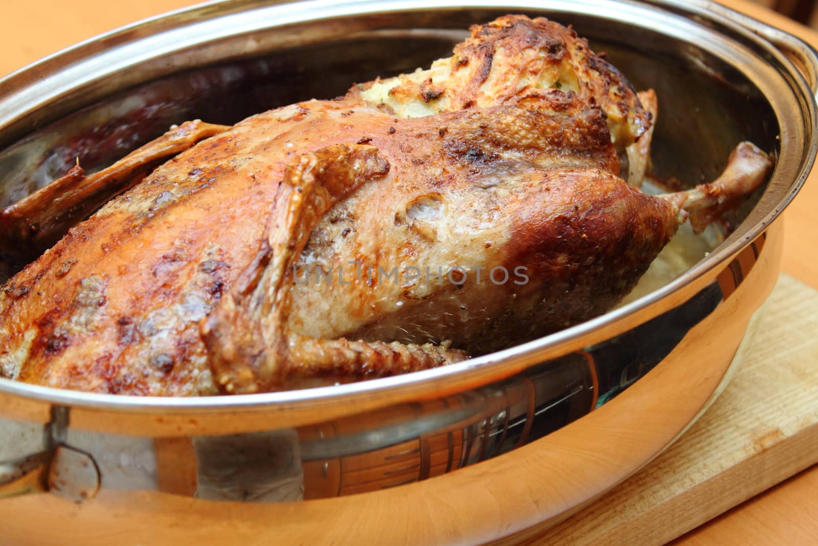 Roasted duck in pan on the wooden desk by artush