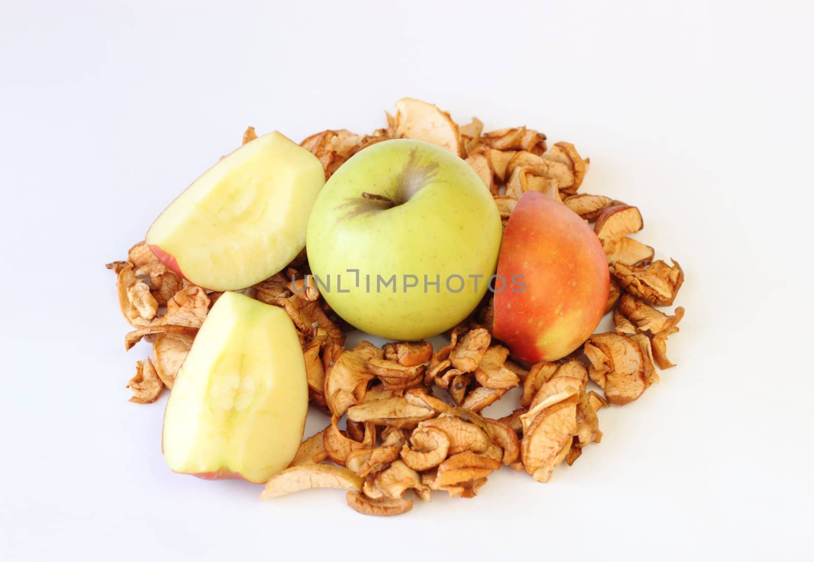 green sliced and dried apples on white background