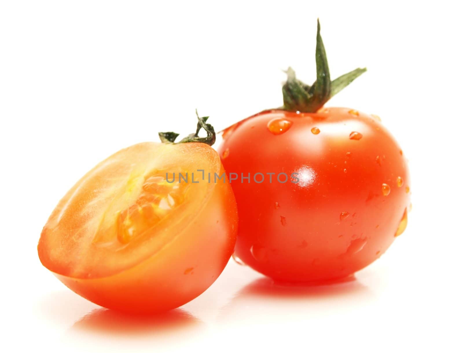 Fresh red tomato toward white background with green grass on top