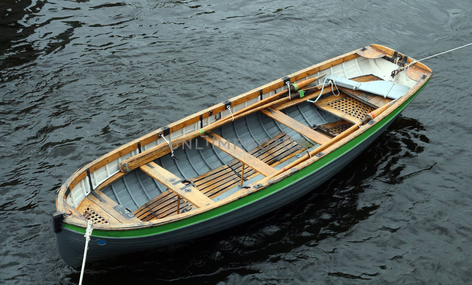 life-boat attached with ropes on water surface