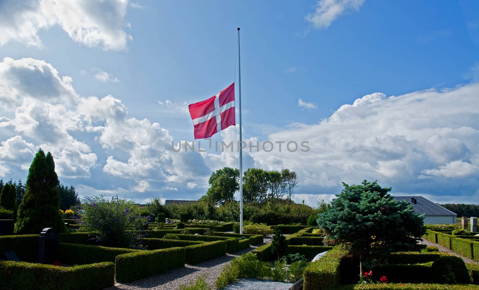 From a danish churchyard with the danish flag at half mast