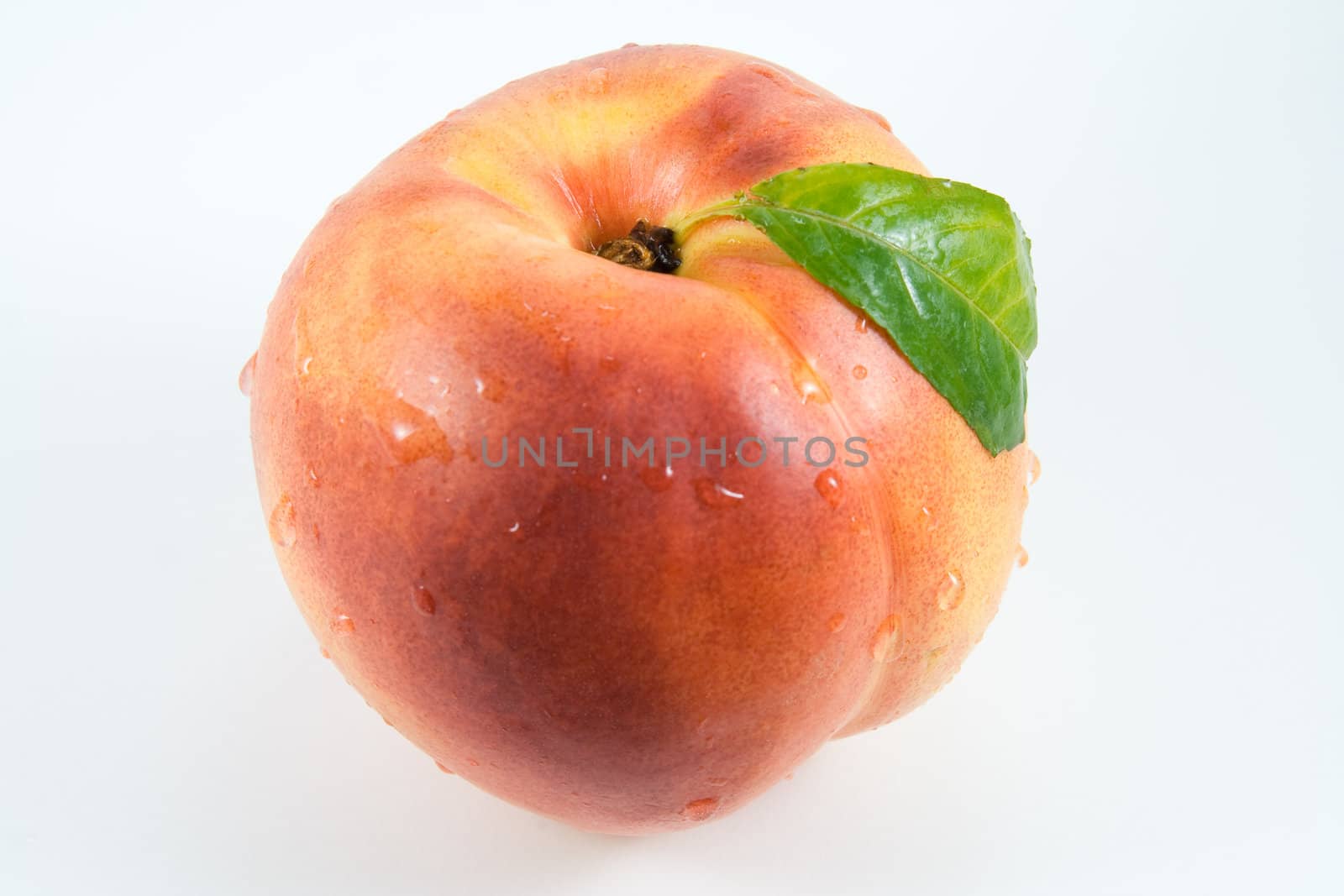 Nectarine with water drops on white background