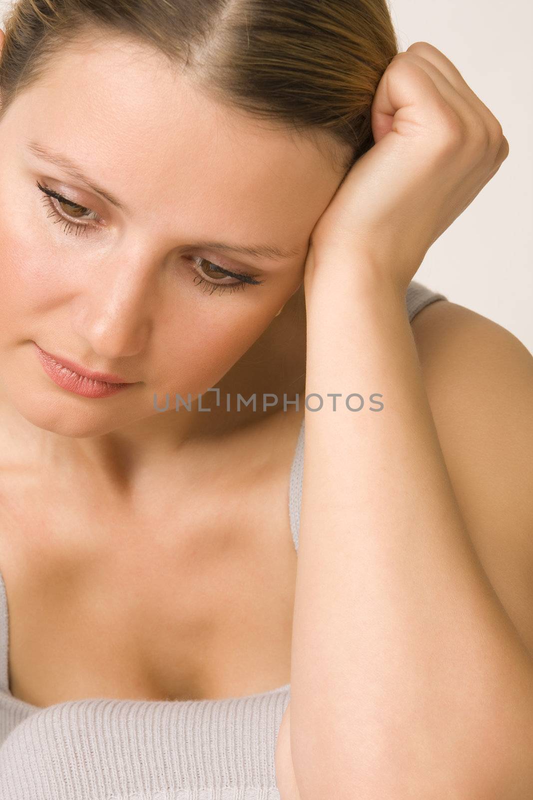 Portrait of young beautiful sad woman on white background