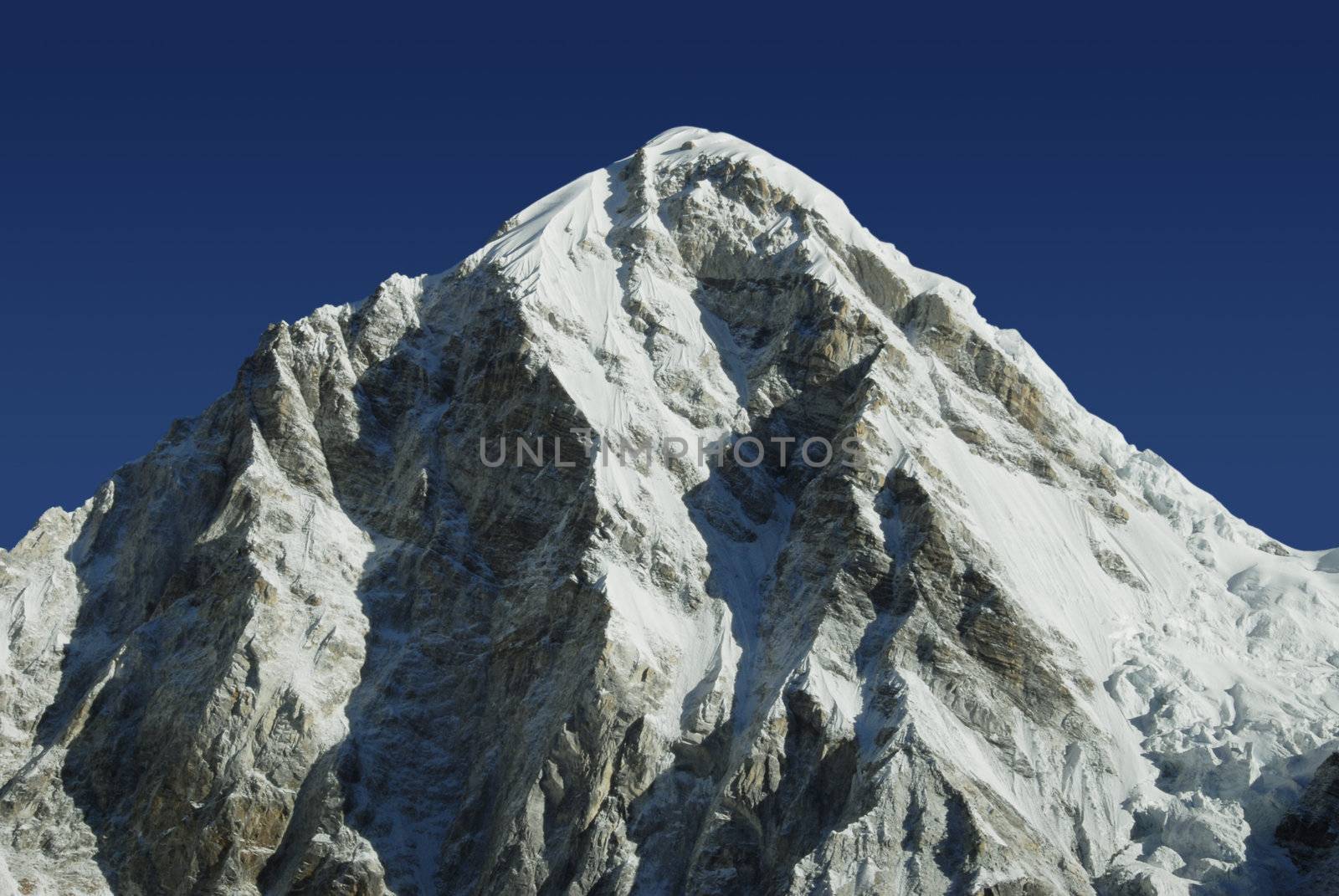 Himalayan mountain Pumori in the Everest mountain range under a bright blue sky
