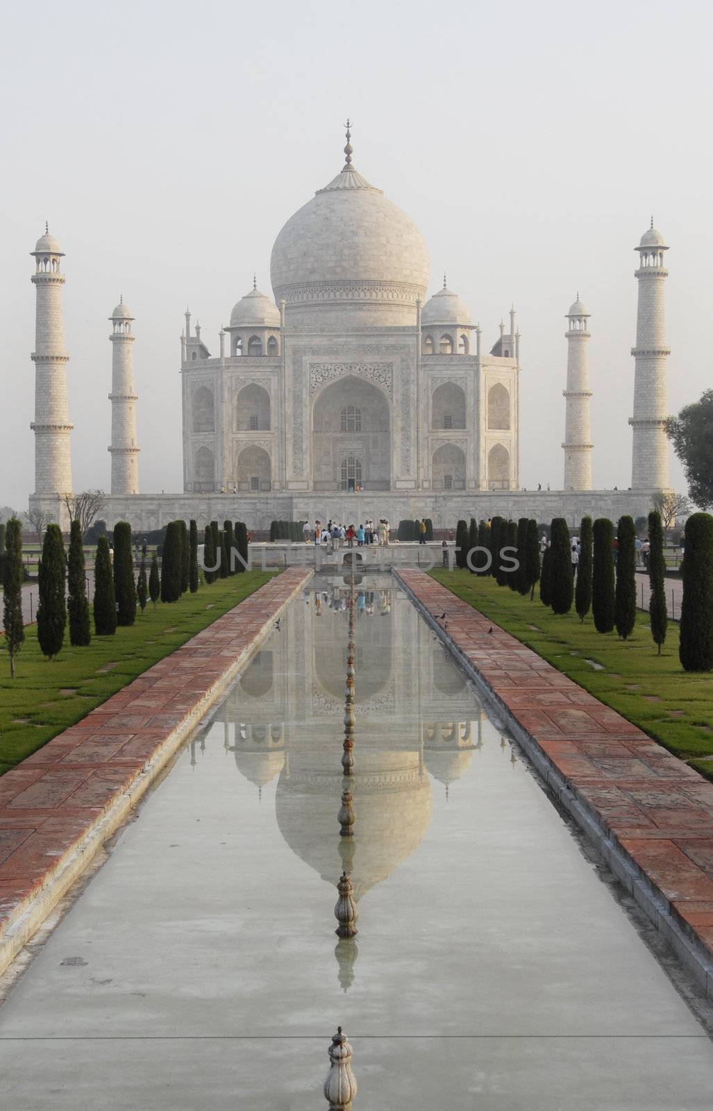 Classic view of the Taj Mahal in Agra, India.  Showing the main mausoleum, the domes and minarets as well as the reflection across the pool and the sculptured garden.